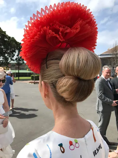 races hairstyle roll with fascinator