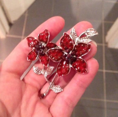 red flow and silver diamontes brooch