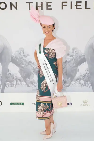 fashions on the field winner with sash on stage dark green and pink 