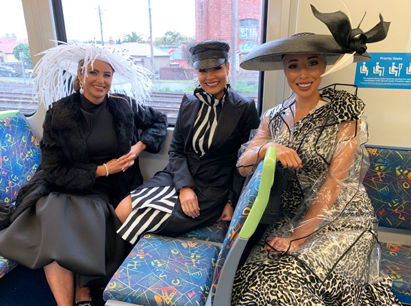 on the train to melbourne cup wearing race dress and millinery