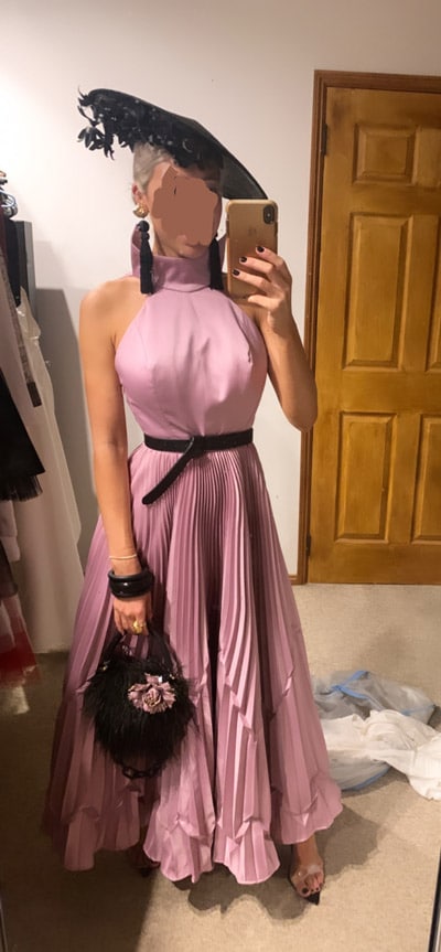 trying on outfit at home pink pleated dress