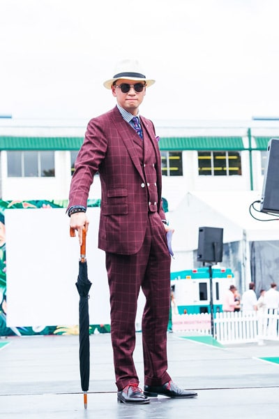 maroon suit with umbrella accessory and print clash